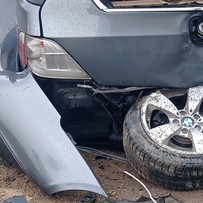 wrecked car being prepared for transport on a trailer